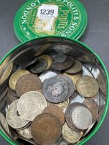 A round tin of assorted coins