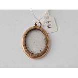 A oval double sided locket 9ct frame 7.2 gms inc.