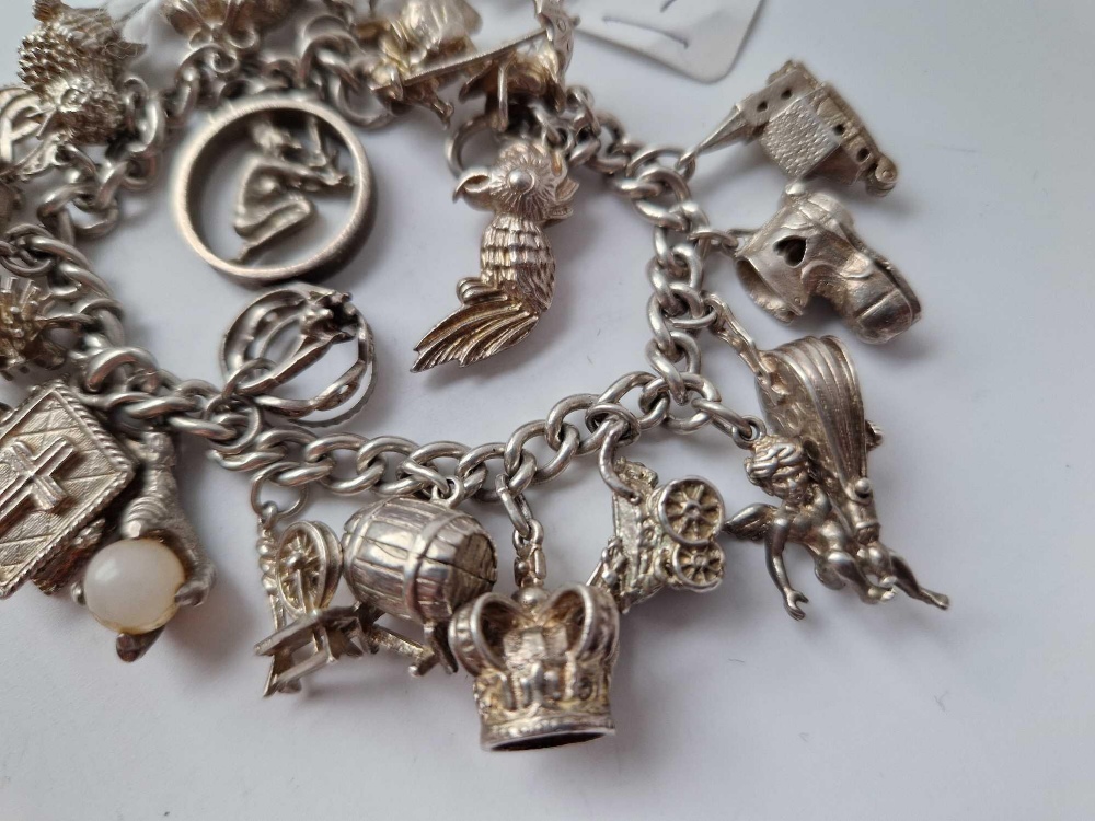 A heavy silver charm bracelet with 20 silver charms 85g - Image 2 of 4