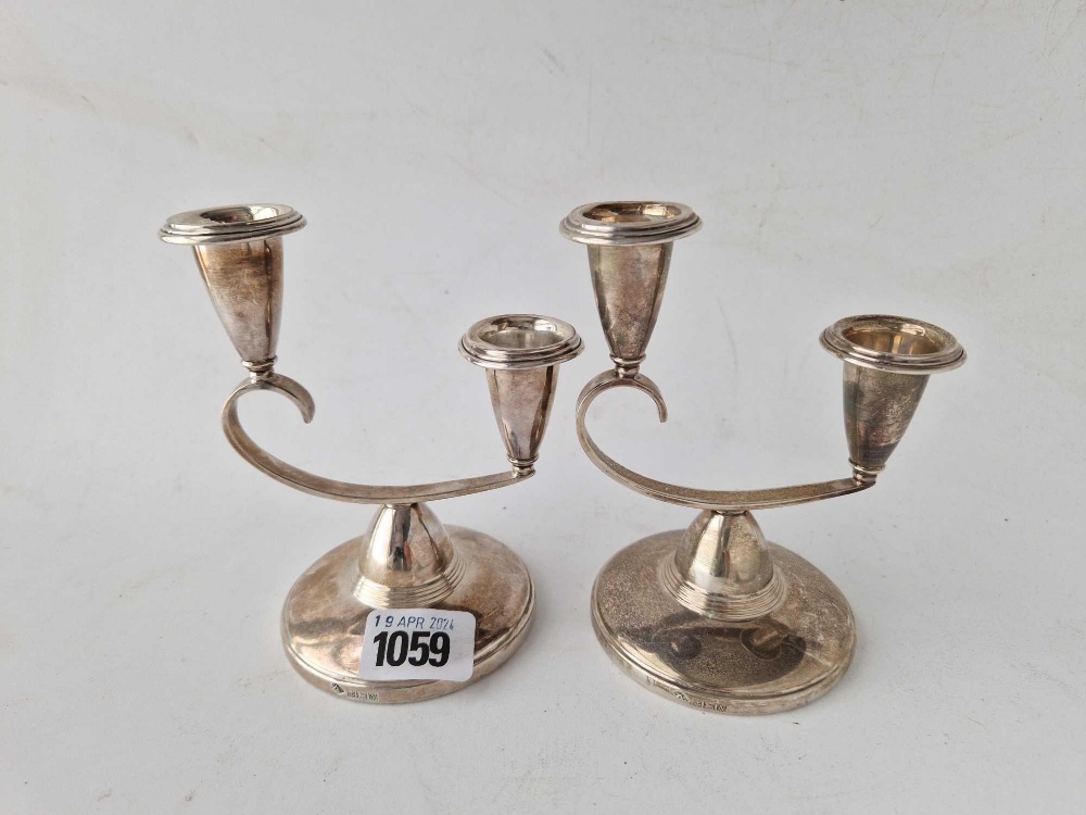A pair of stylish candle holders on circular bases, 5 inches high, Birmingham 1968