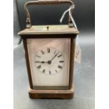 A brass repeating carriage clock complete with key slight crack to front glass