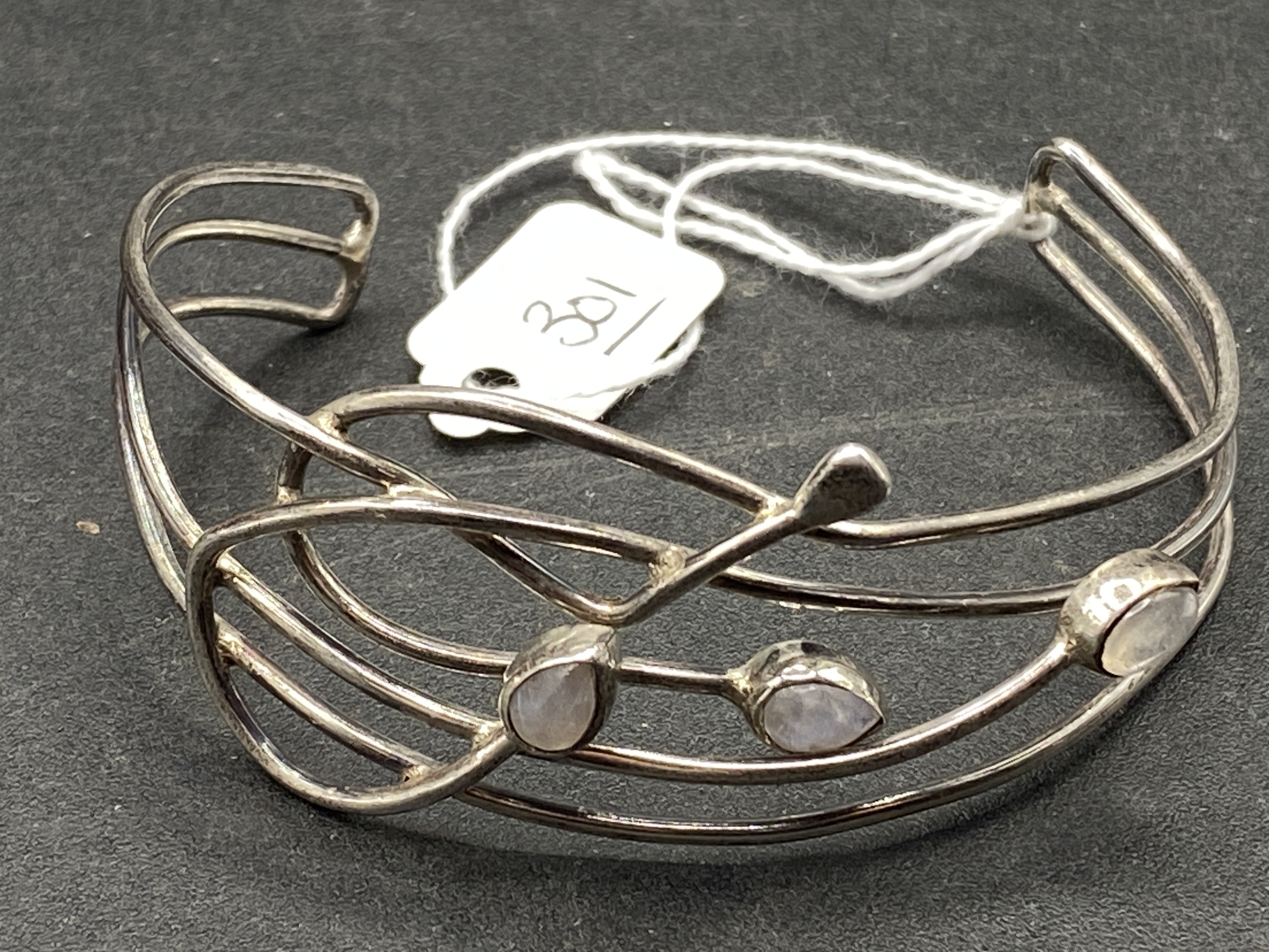 A silver & moonstone half torque bangle 15g