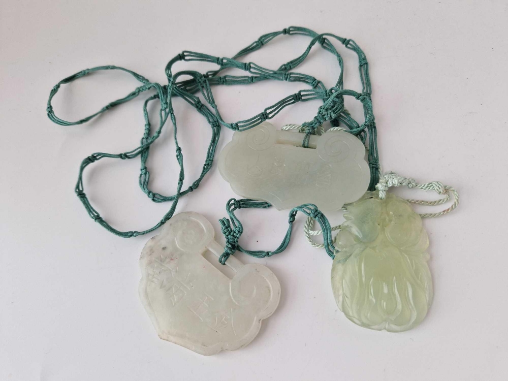 Three carved jadeite pendants