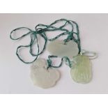 Three carved jadeite pendants