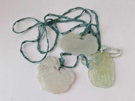 Three carved jadeite pendants