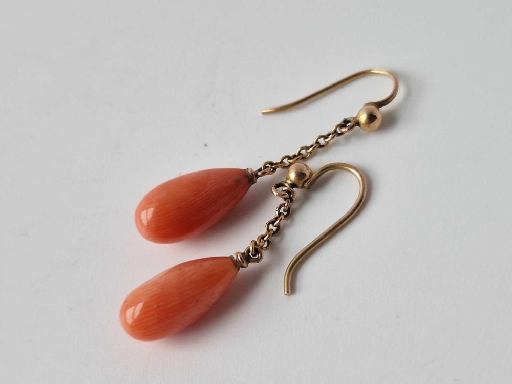 A pair of gold mounted coral earrings