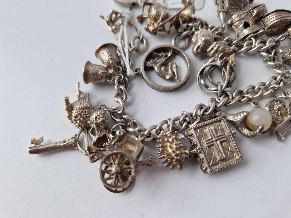 A heavy silver charm bracelet with 20 silver charms 85g - Image 3 of 4