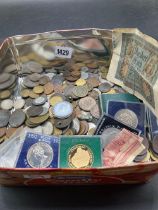Tin of coins and banknotes