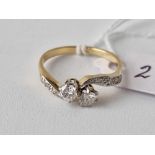 Antique Edwardian 2 stone diamond crossover ring with diamond set shoulders in 18ct and platinum,