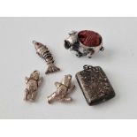 A miniature silver pig pin cushion together with four other silver charms