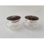 A pair of tortoise shell and silver top jars with glass bodies, 4 inches diameter