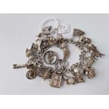 A heavy silver charm bracelet with 20 silver charms 85g