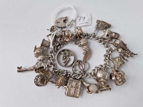A heavy silver charm bracelet with 20 silver charms 85g