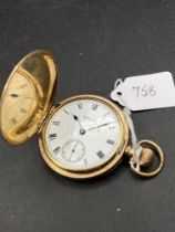 A gilt hunter pocket watch by WALTHAM with seconds dial