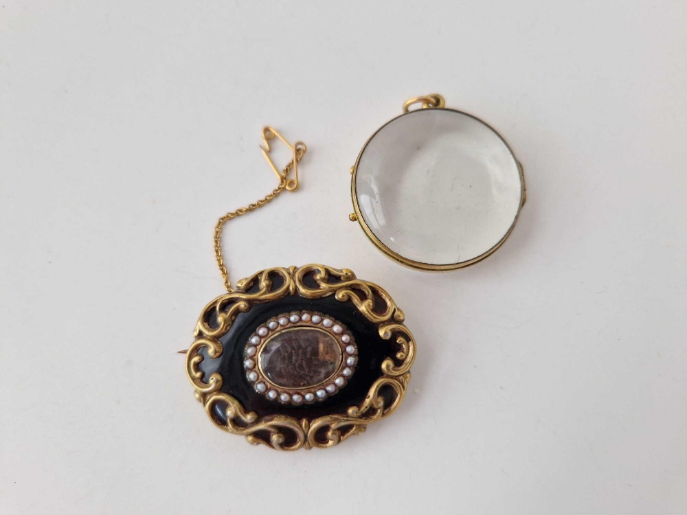 An antique mourning brooch and double sided locket