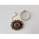 An antique mourning brooch and double sided locket