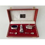 A boxed three piece cruet set with B.G.L's and cruet spoons, Sheffield