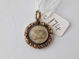 A Georgian locket with crisp chased border plaited hair centre the back dated 1829 6.4 gms inc.