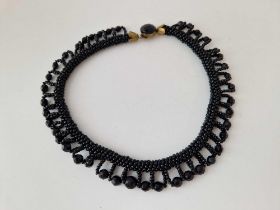 A black bead collar necklace
