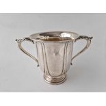 A good quality Edwardian cup with two leaf capped handles, 5 inches high, London 1905, by HE & Co,