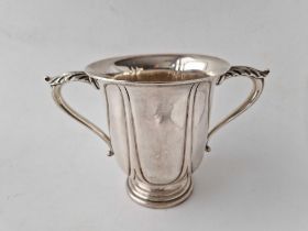 A good quality Edwardian cup with two leaf capped handles, 5 inches high, London 1905, by HE & Co,