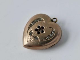 A gold heart locket set with gem stones, 5 g