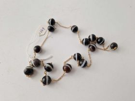 A banded agate style glass bead necklace 28”