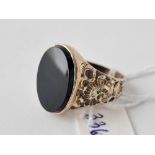 A large silver onyx ring with embossed shank