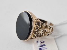 A large silver onyx ring with embossed shank