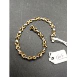 A two colour 9ct gold hugs & kisses bracelet 7.8g