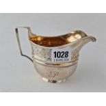 A good quality George III oval cream jug with a bright cut band, gilt interior, London 1806, 170 g