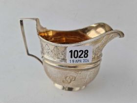 A good quality George III oval cream jug with a bright cut band, gilt interior, London 1806, 170 g