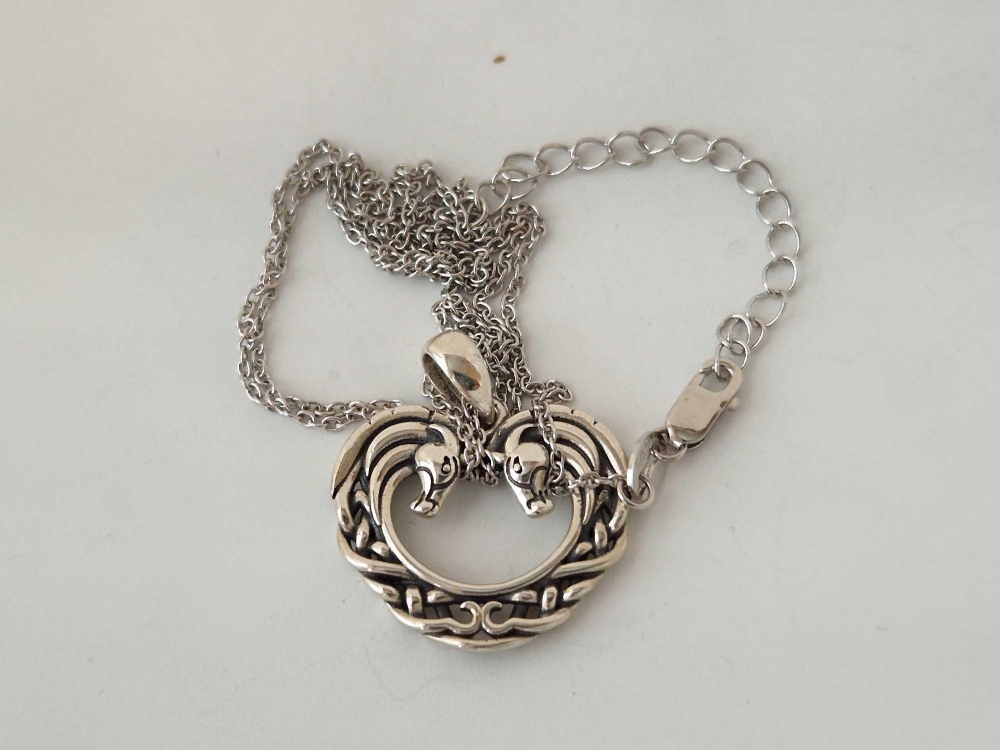 A boxed silver horseshoe pendant and chain