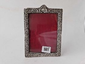 A Victorian photo frame with embossed border and arched top, 7" high, Chester 1897 by JS?