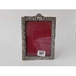 A Victorian photo frame with embossed border and arched top, 7" high, Chester 1897 by JS?