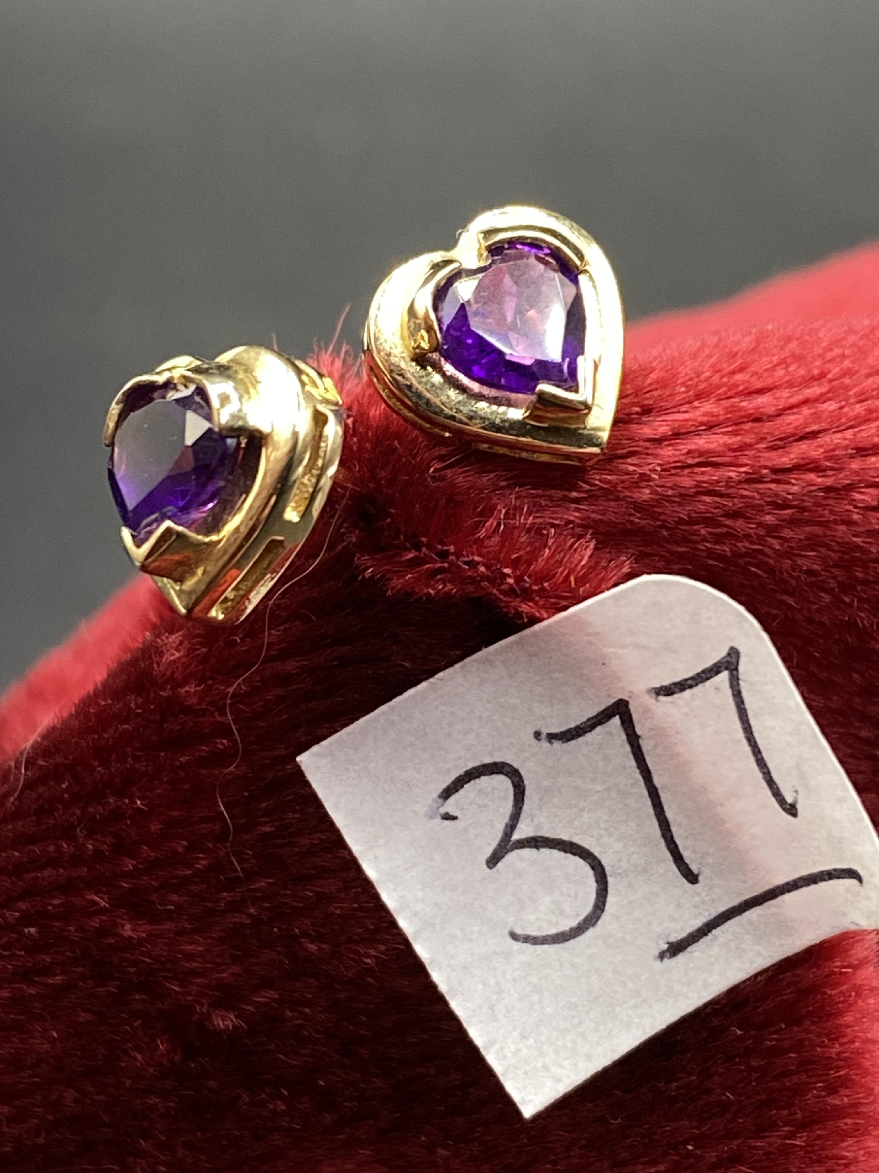 A pair of heart shaped modern amethyst earrings