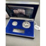 Cased 1887 shilling & 1977 silver proof crown