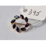 A small gold brooch set with sapphires