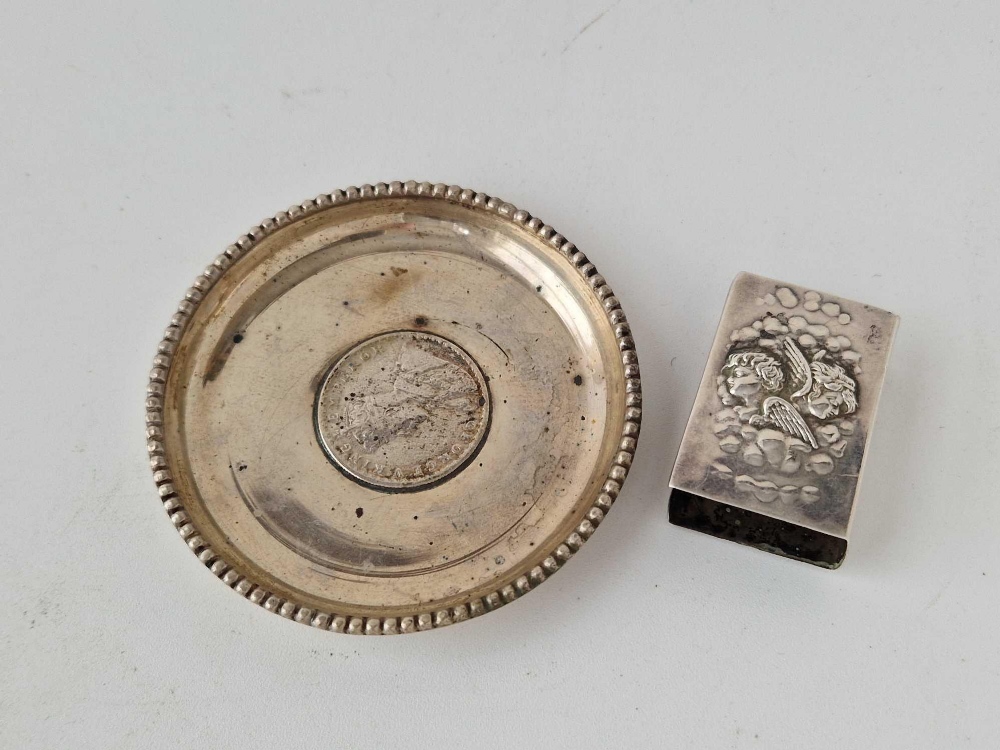 A circular dish inset with a coin dated 1918 and an angel decorated match box holder 1903
