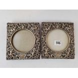 A good pair of decorative photo frames pierced and embossed with scrolls and cherubs, 6" high,