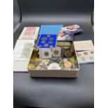 A tin of world coins and small bank not album