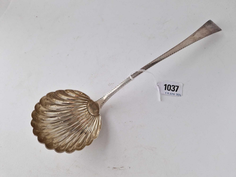 An early George III soup ladle with shell shaped bowl and wriggle work engraved border, London 1776,