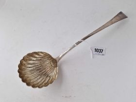 An early George III soup ladle with shell shaped bowl and wriggle work engraved border, London 1776,