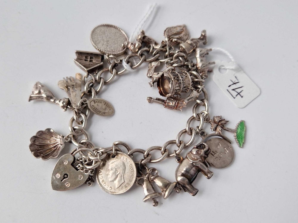 A silver charm bracelet with 16 silver charms 47.4g