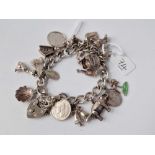 A silver charm bracelet with 16 silver charms 47.4g