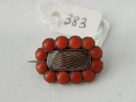 An antique Georgian gold and coral set mourning brooch