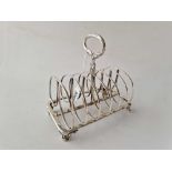 A large seven bar toast rack on scroll feet, Sheffield 1833, 307 g