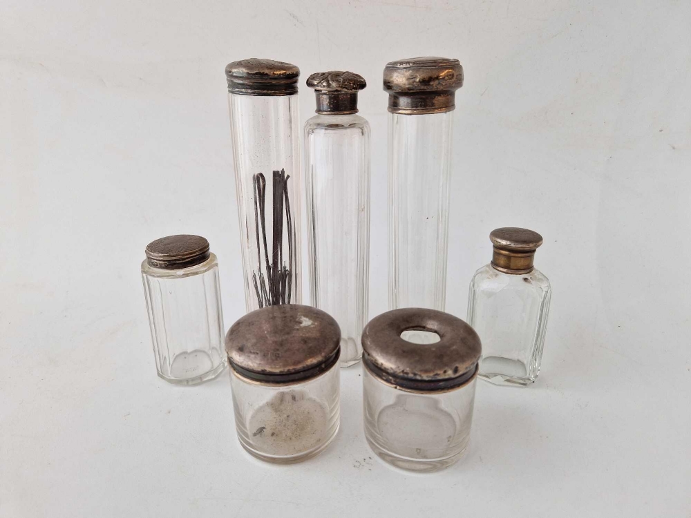 Seven various silver top jars with glass bases