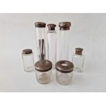 Seven various silver top jars with glass bases