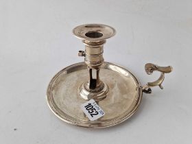 A George II chamber candlestick with leaf capped scroll handle, 5.75 diameter, London 1758, 325 g